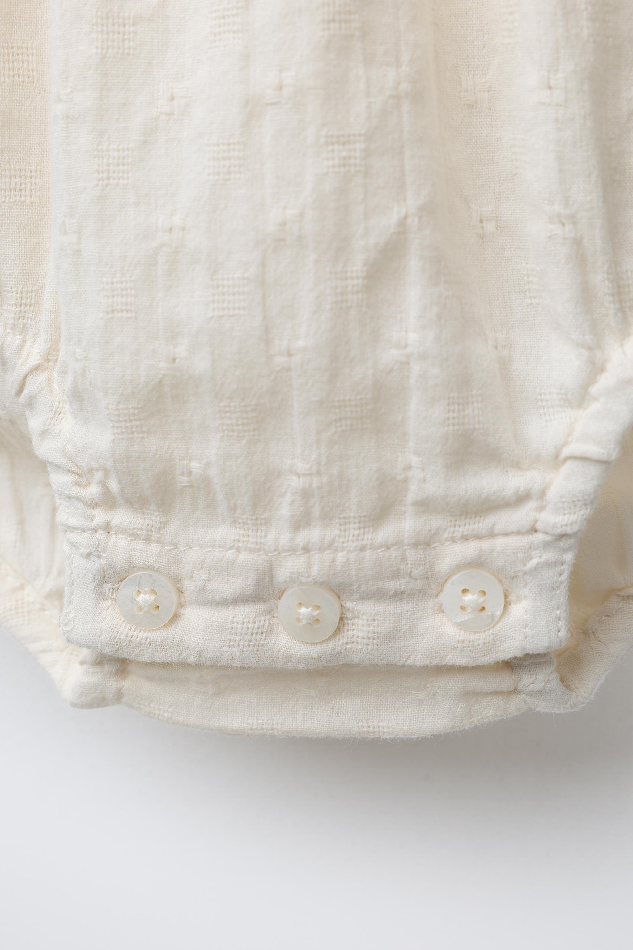 CONTRAST EMBROIDERED BODYSUIT